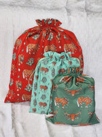 Load image into Gallery viewer, Western Christmas Reusable Gift Bags - Red Ponies Print
