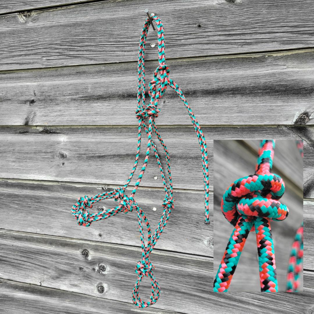 Turquoise, pink, and black yearling size four-knot rope halter.